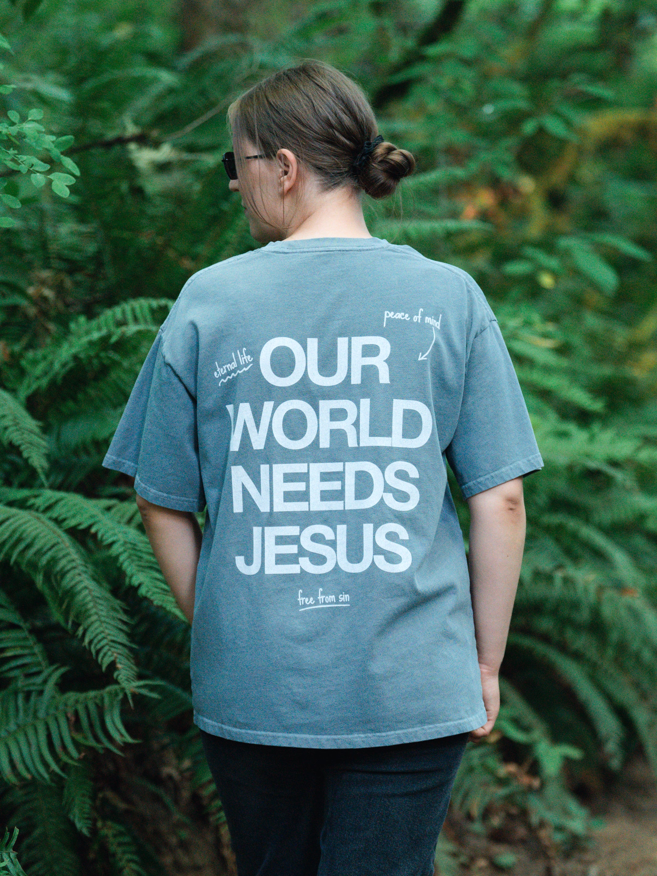 OUR WORLD NEEDS JESUS UNISEX TEE