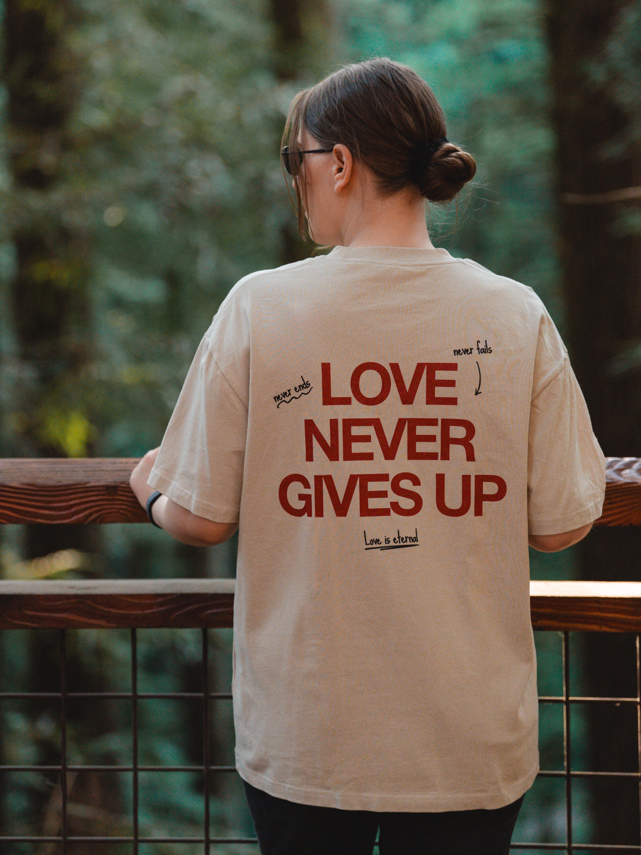 LOVE NEVER GIVES UP UNISEX TEE