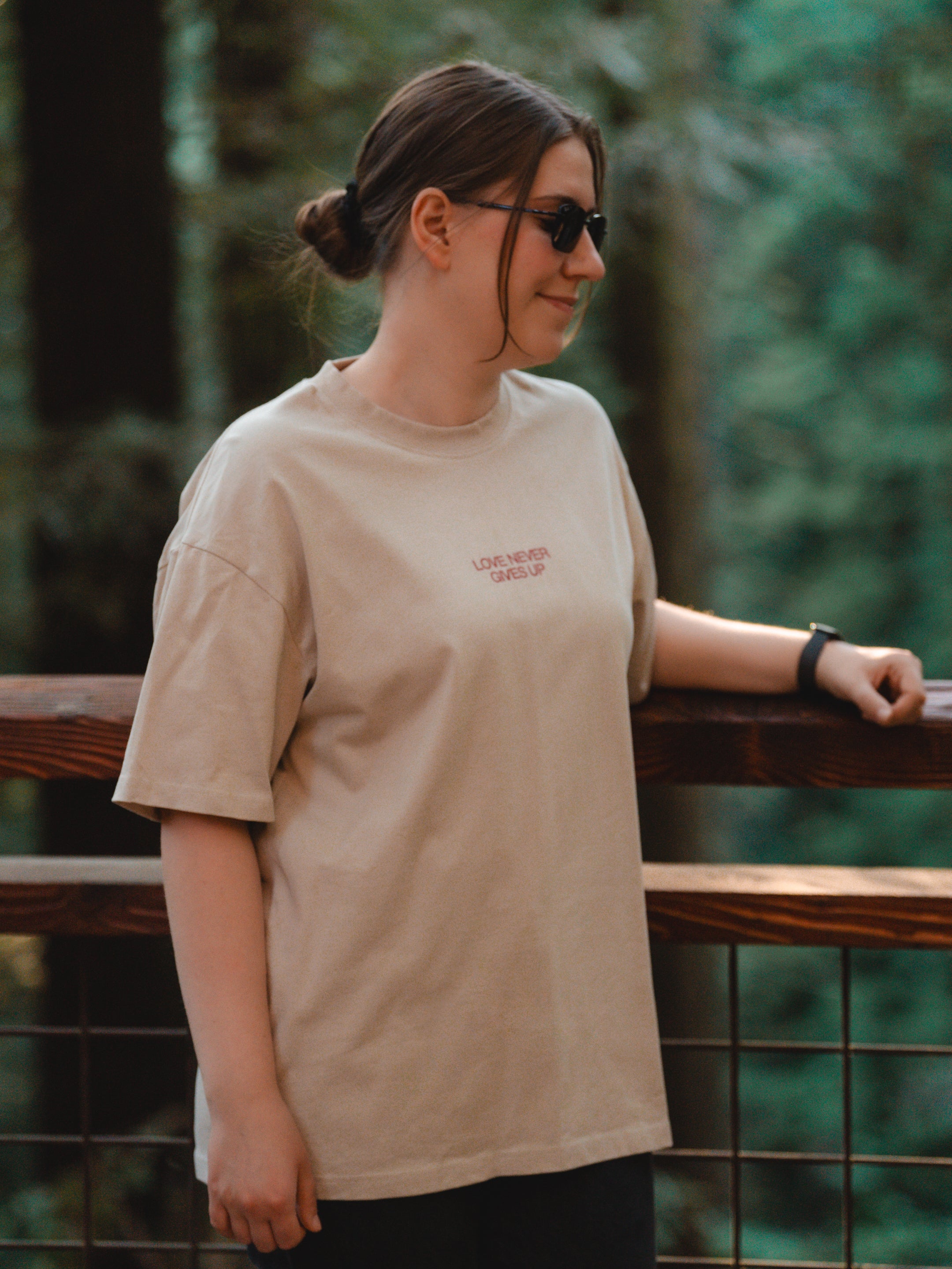 LOVE NEVER GIVES UP UNISEX TEE